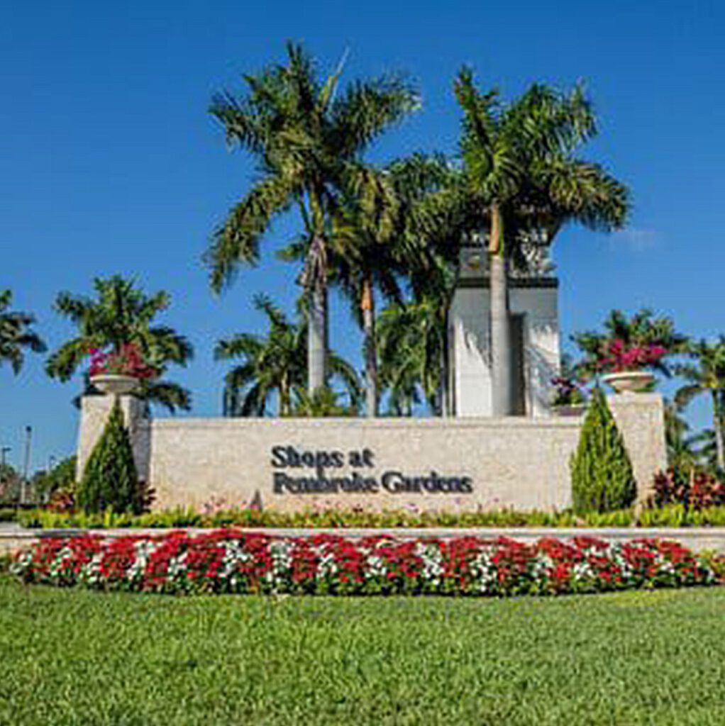 Pembroke Pines Sign Board with trees in Back ground and garden front at morning time